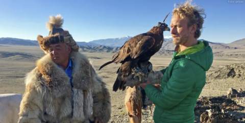 Photo showing a falconer and Friedtjof Detzner with a falcon on his arm.